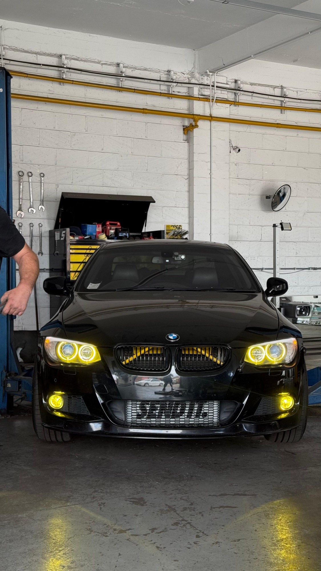 Black BMW E92 with yellow angel eyes, yellow grille slats and front splitter fitted at Ignite Autos